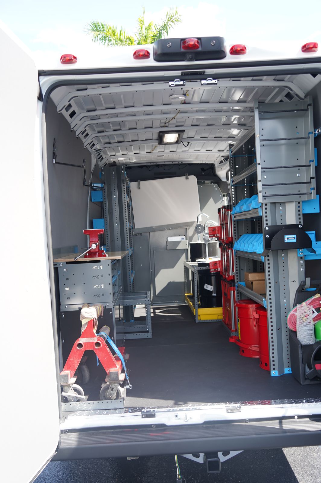 Inside the mobile service van — organized shelving with tools, safety cans, and equipment